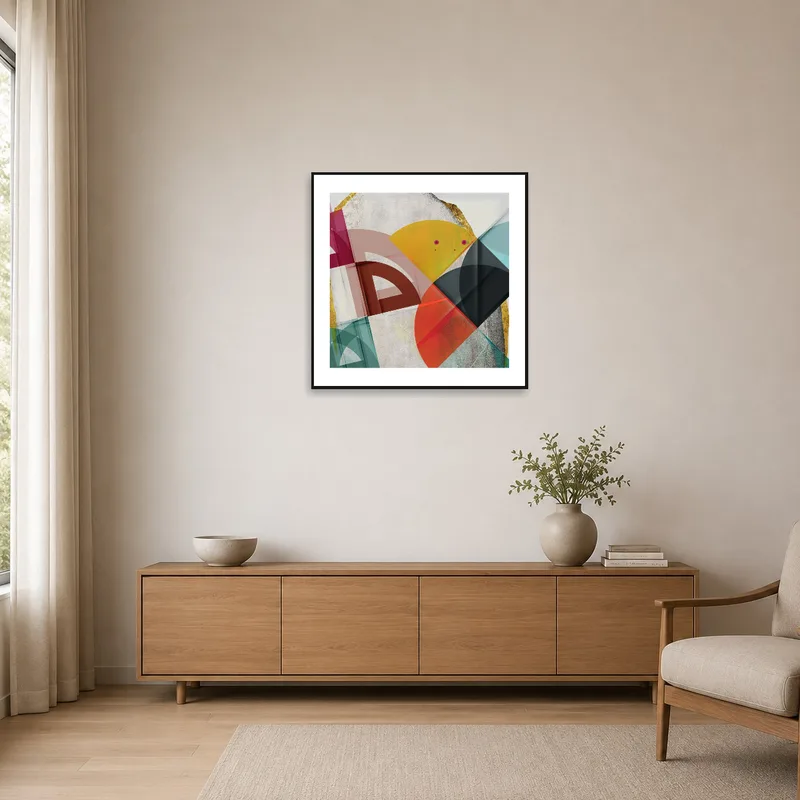 Bold geometric shapes contrast with the minimalist white walls and simple furnishings.
