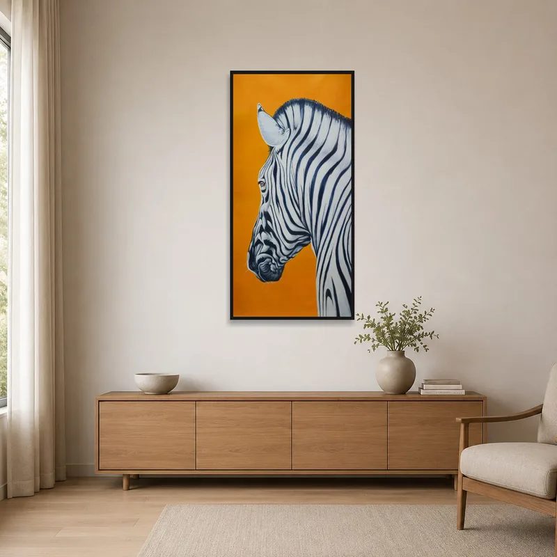 The zebra portrait on orange adds a splash of color to the minimalist setting.