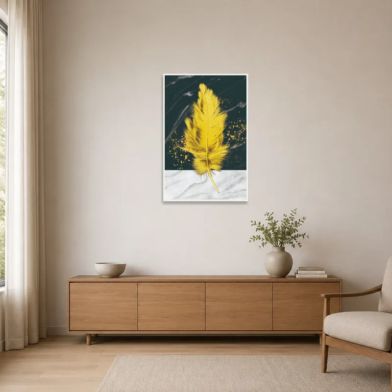 A striking yellow feather on a sleek marble and dark background in a minimalist space.